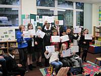 Friends of Denehurst Park School Logo design competition 2014. Four local schools were involved in the competition. Seen here in Spotland Library are the winner Natalie Jones and the runners up with their prizes.